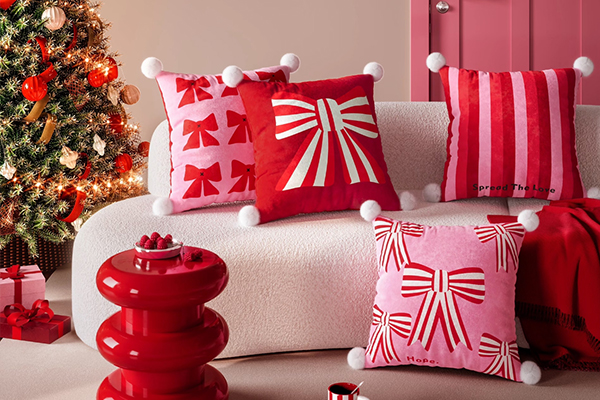A collection of colorful bow pillows on a sofa