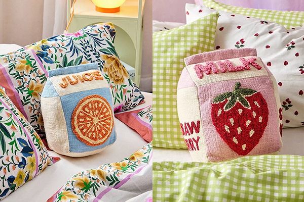 A person relaxing on a couch with supportive, soft pillows.