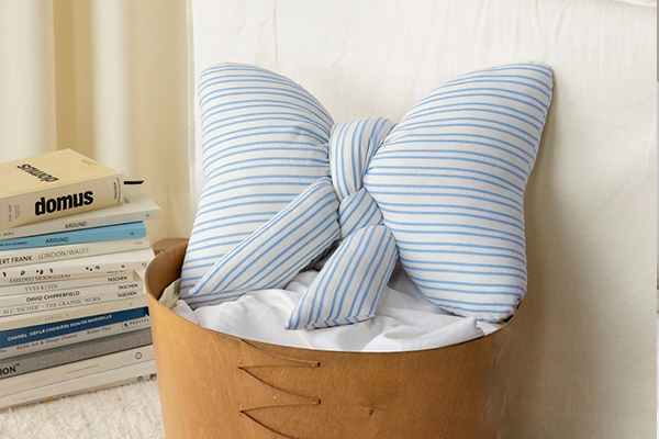 A beautifully wrapped bow pillow as a gift