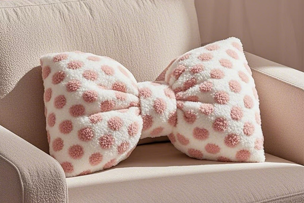 A person using a bow pillow for lumbar support while reading