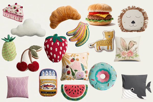 A collection of novelty pillows in various fun shapes like a croissant, a leaf, and a cat.