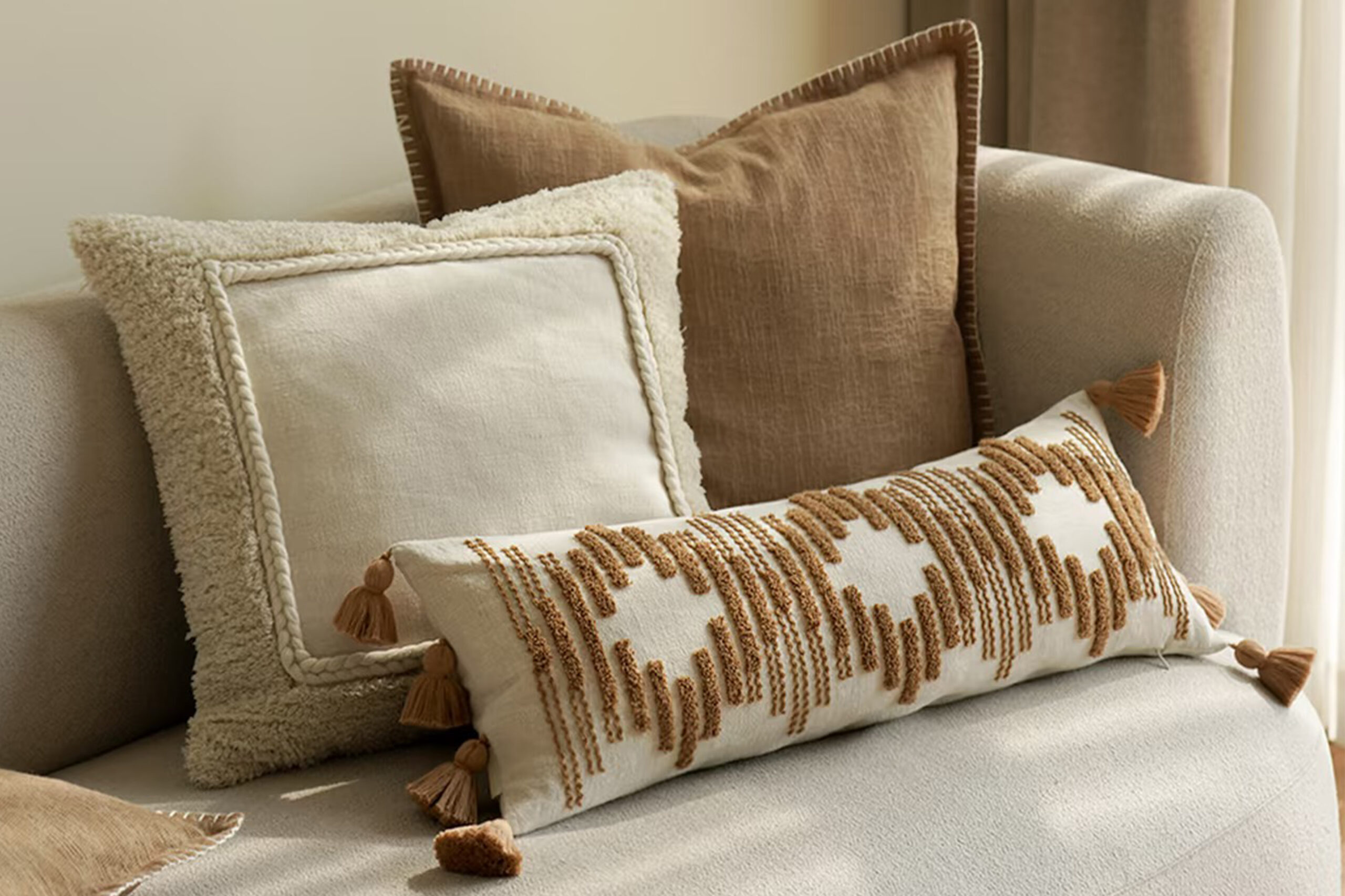 A collection of linen throw pillows on a sofa